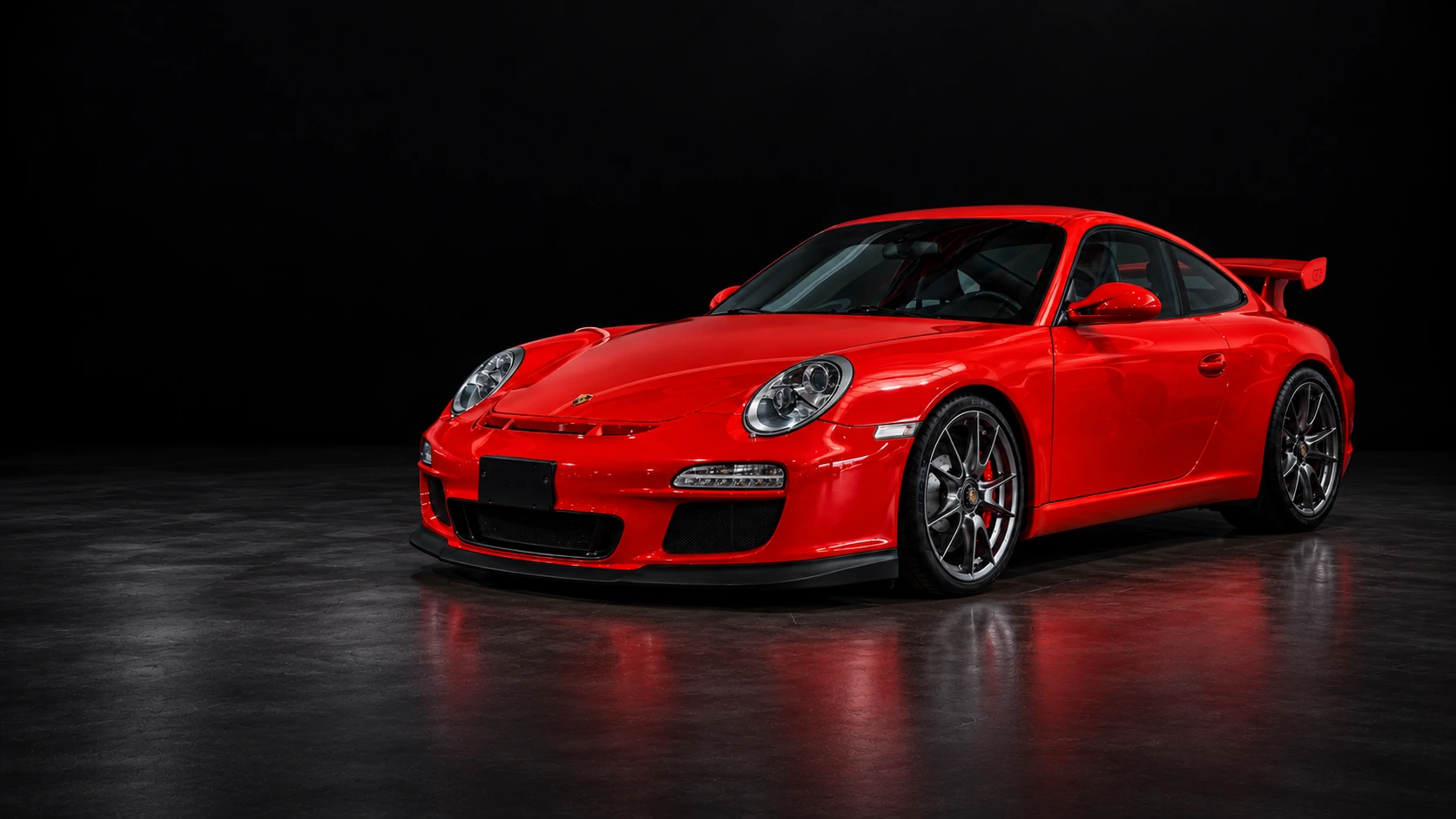 Porsche GT3 rojo completo sobre suelo negro; edición de la fotografía A88A0683 de ARTECH